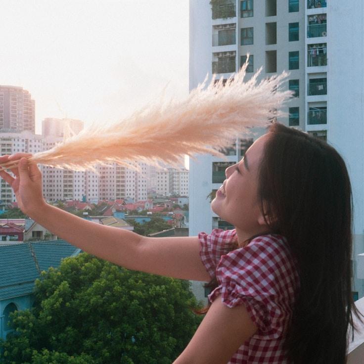 Kaveri Mehta, Lead Design Curator at Harbor Quartz Leaf, reviewing corporate floral arrangements